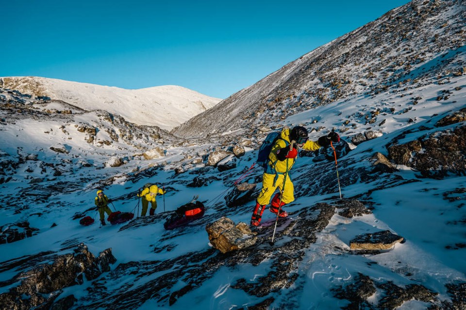 Three members of Kevin Vallely's expedition cross a rocky section of Baffin Island's Paalik Valley, February 2023. | Howie Stern 