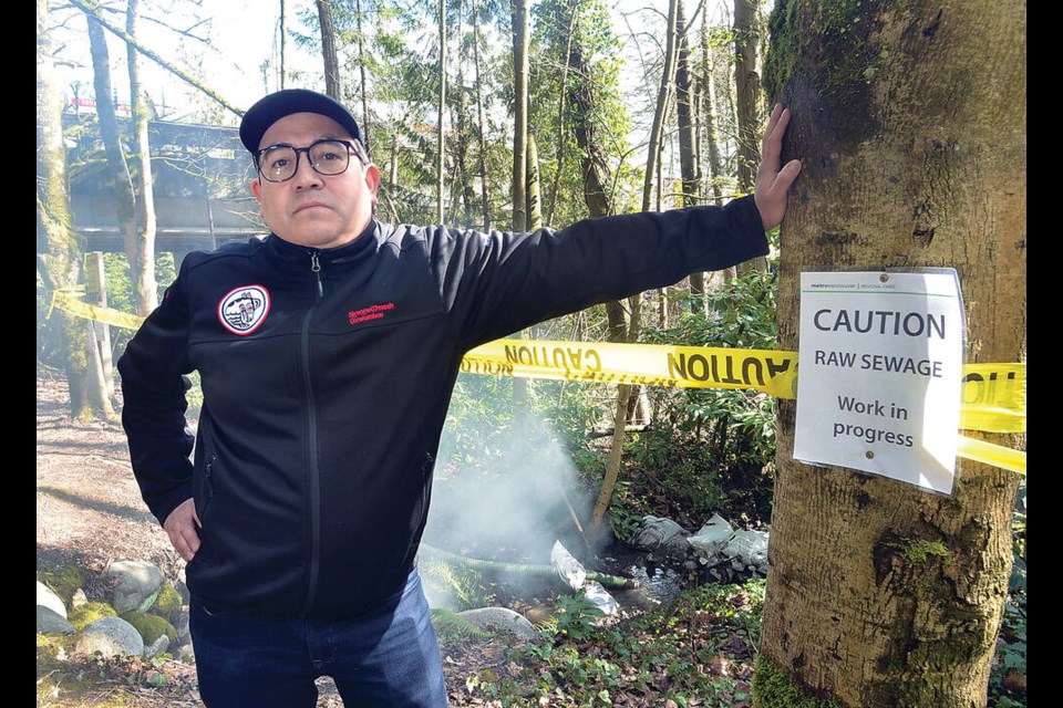Squamish Nation elected council member Sxwíxwtn (Wilson Williams) stands in front of the leak site. The steam in the air is related to finding the source of the leak, he said. | Paul McGrath / North Shore News 