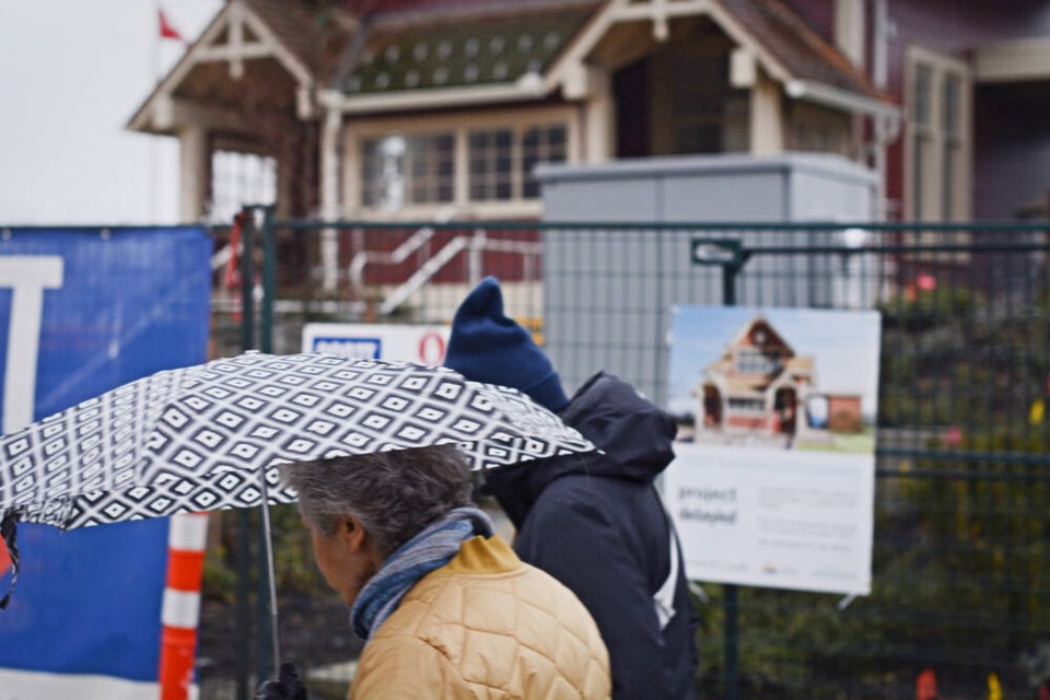 Walkers pass by West Vancouver's Ferry Building on Jan. 26. A multimillion-dollar restoration project of the heritage site has faced delays. | Nick Laba / North Shore News 