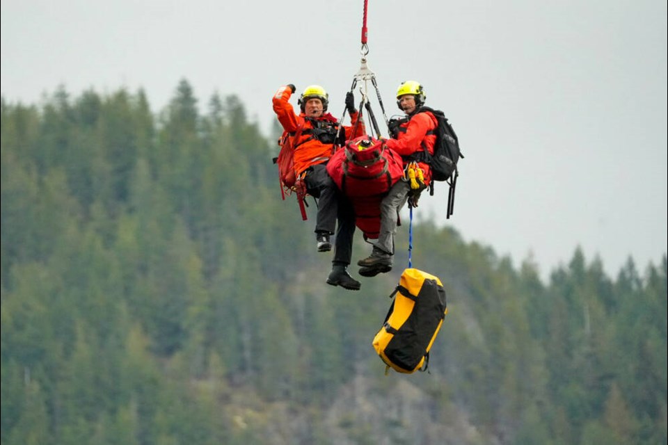 A North Shore Rescue member makes a hand signal during Class D fixed line helicopter training on Thursday. | Silvester Law 