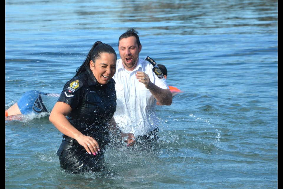 North Vancouver RCMP, West Vancouver Police Department and North Shore Rescue members, along with supporters, take part in a polar plunge off Ambleside Park, March 8, 2023, to benefit Special Olympics BC. | Brent Richter / North Shore News