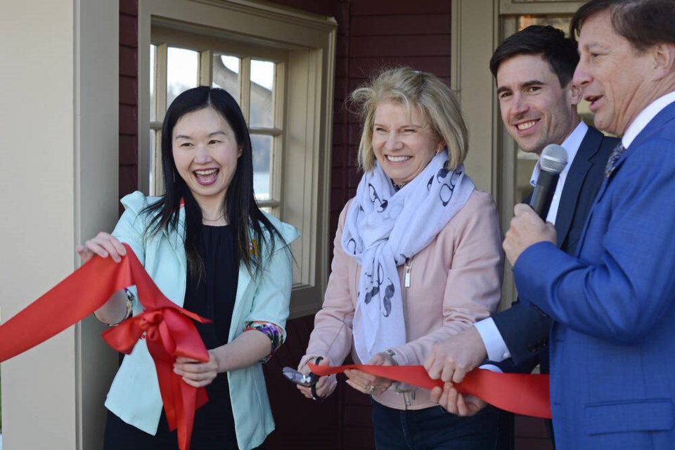 B.C. Minister of Municipal Affairs Anne Kang holds up the ceremonial ribbon as it is cut by former West Vancouver mayor Mary-Ann Booth, alongside MP Patrick Weiler and current Mayor Mark Sager. Sager gave the cutting privilege to Booth, as the restoration project was spearheaded under her leadership. | Nick Laba / North Shore News 