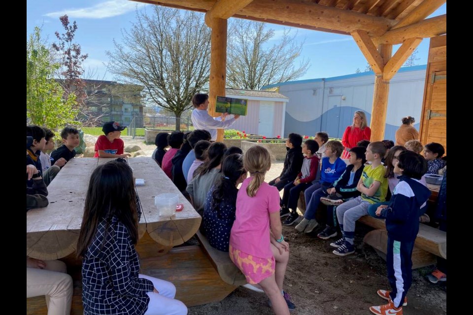 West Van Mayor Mark Sager reads a short story on kindness to a group of 50 Grade 3 students at École Pauline Johnson April 27. | Mina Kerr-Lazenby / North Shore News