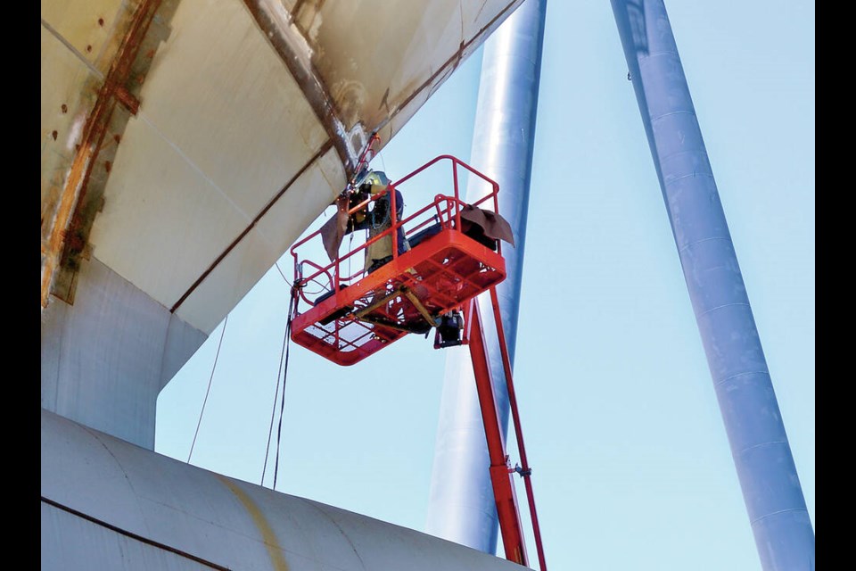 A welder works on the hull of the massive joint support ship taking shape at Seaspan's Vancouver Shipyards in July 2022. | Paul McGrath / North Shore News 