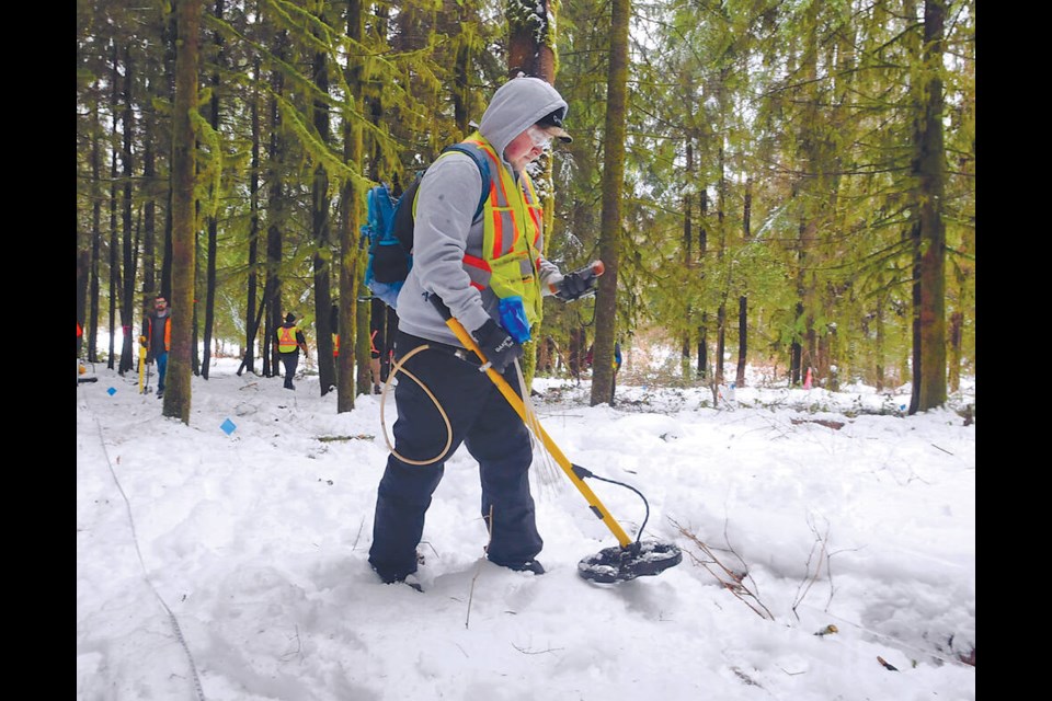 UXO team member Riley Dodginghorse of the Tsuutina Nation in Alberta under contract with Department of National Defence uses a metal detector to scour the Blair Rifle Range Lands for unexploded mortar shells and grenades, Feb. 27, 2023. | Paul McGrath / North Shore News 