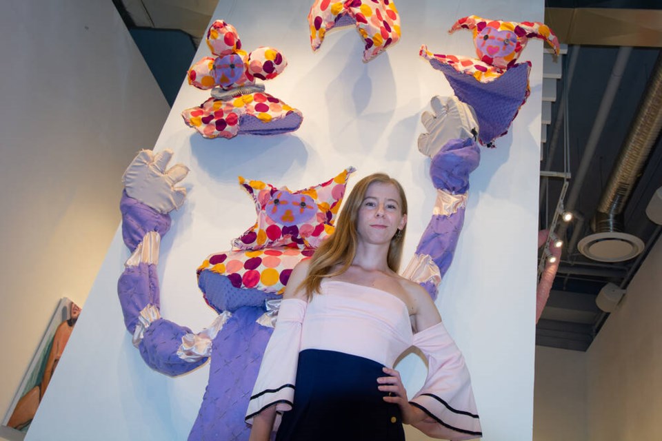 Exhibit curator and North Van Arts social engagement manager Andy Warner poses in front of 'Miss Funny Business,' a wearable costume by Vancouver-based artist Ivy Hazard. | Nick Laba / North Shore News 