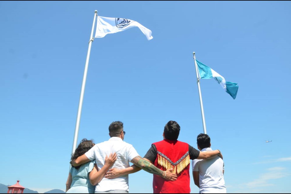 Members from the three Nations come together to welcome their flags to Stanley Park Tuesday, May 16. Tsleil-Waututh councillors Charlene Aleck and Dennis Thomas are pictured here with Squamish Nation councillor Wilson Williams and councillor Brett Sparrow from the Musqueam Indian Band. | Mina Kerr-Lazenby / North Shore News 