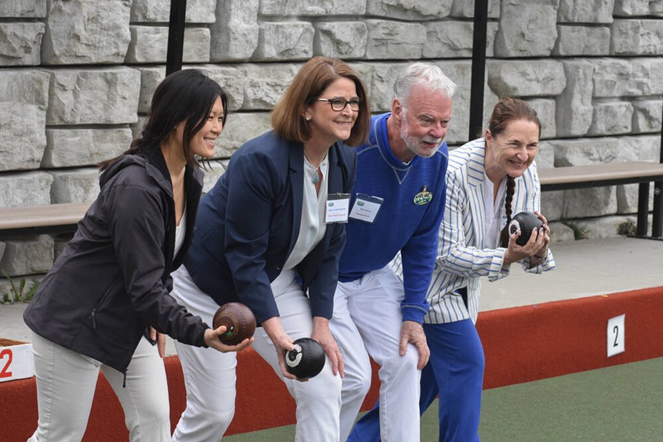MLA Bowinn Ma, City of North Vancouver Mayor Linda Buchanan, North Vancouver Lawn Bowling Club president Bruce Murray, and MLA Susie Chant throw the commemorative first bowl during a celebration of the club's 100th anniversary Sunday. | Jordan Copp, North Shore News 