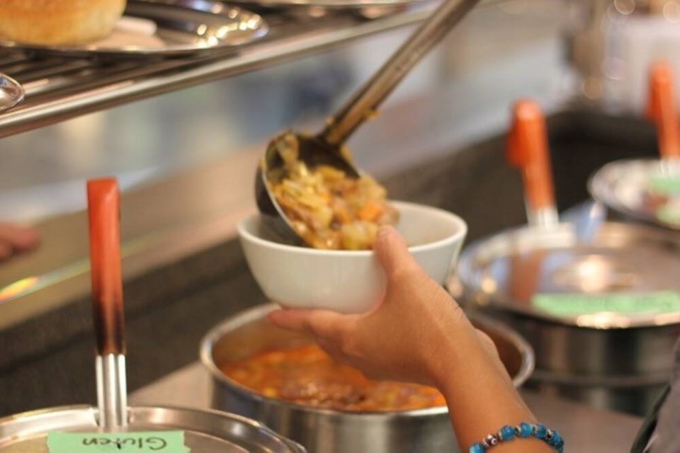 A server dishes up a ladle of Beef Stew. The Soup Meister's Nephew will bring back classic recipes, with a few added twists. | Courtesy of Evan Paul 