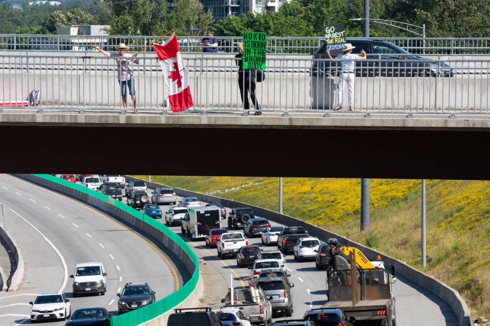 A group of demonstrators gathers on the Mountain Highway overpass on Thursday, June 22. | Nick Laba / North Shore News 