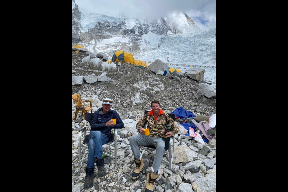 Bruce McAdie and a climbing partner from his group celebrate with scotch at base camp on May 18 after descending from the summit. | Bruce McAdie