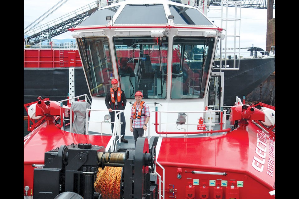 Jordan Pechie, senior vice-president Seaspan Marine Transportation (left) and Vincent Percy, director of operations for HaiSea Marine, stand aboard HaiSea Wamis, the world’s first all-electric tugboat. | Paul McGrath / North Shore News 