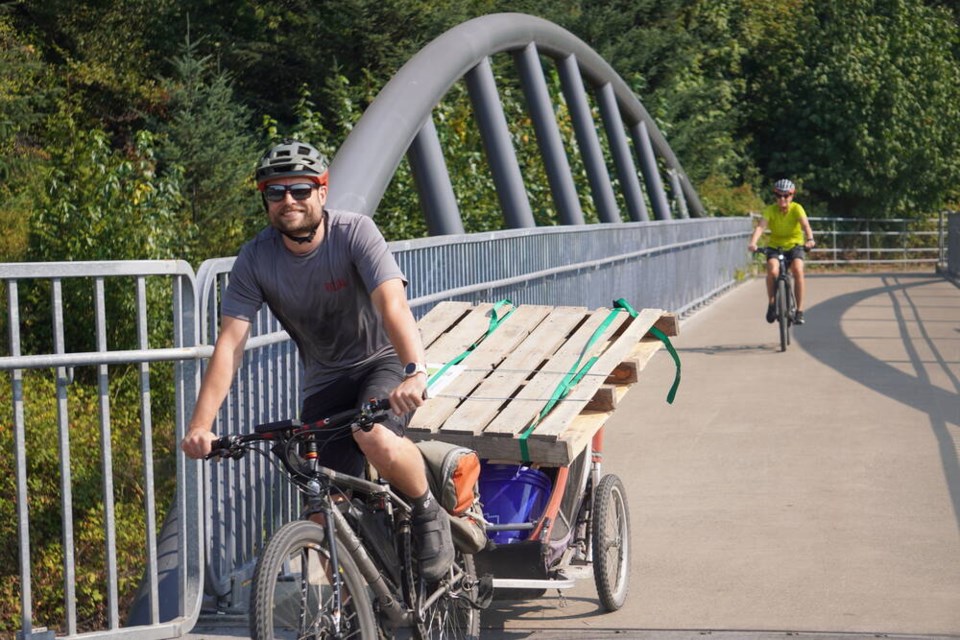 A racer with a full load of cargo crosses the overpass above Third Street East near Heywood Street in North Vancouver. | Duncan Wilcock 