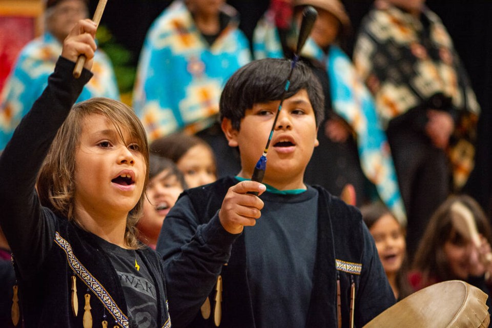 Stanley Kwu7s Harry, 8, and Matteo Baker, 10, of Capilano Little Ones School drum and sing during a procession at Monday’s ceremony to celebrate First Nations assuming jurisdiction over their education systems. | Nick Laba / North Shore News 