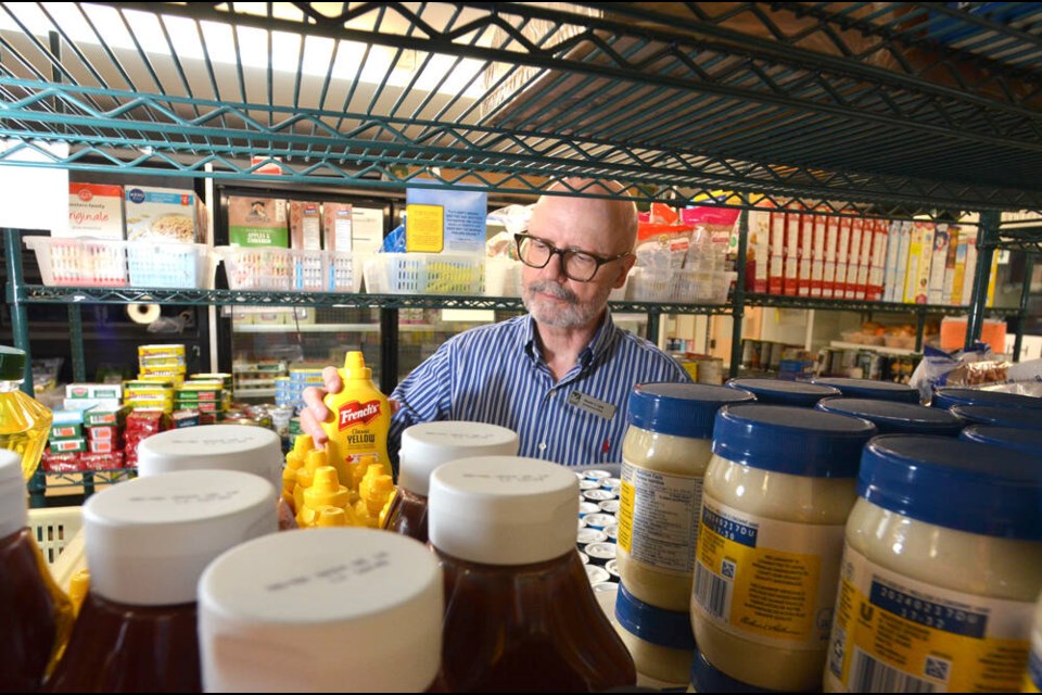 Harvest Project development officer Kevin Lee sorts through groceries to be donated by the North Vancouver non-profit. The Harvest Project is celebrating 30 years of giving North Shore residents in need a hand up. | Paul McGrath / North Shore News 