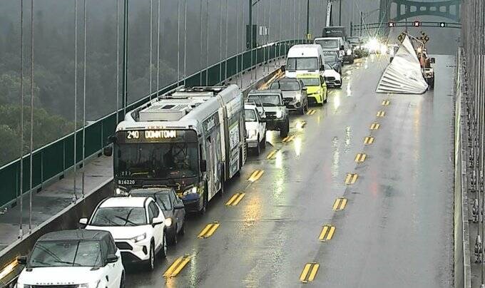 Traffic was stalled for over an hour as crews worked to dislodge a large metal object that got wrapped around an overhead section of the Lions Gate Bridge. | DriveBC
