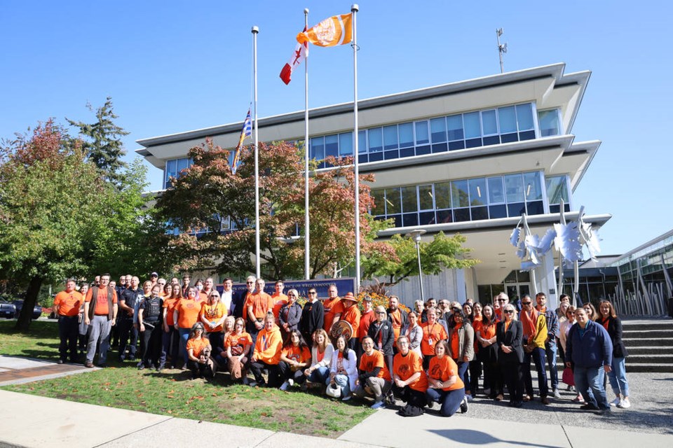 Members of the public gathered with municipal staff and elders from the Squamish Nation to honour residential school survivors with a raising of the Survivors’ Flag at muncipal hall on Friday. | DWV 