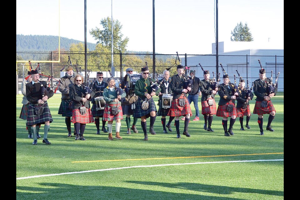 Bagpipers lead the way before the first senior boys football game played on the new Argyle Secondary turf field Oct. 27, 2023. The visiting West Vancouver Highlanders narrowly beat the host Pipers 14-13 to christen the new field. | Paul McGrath / North Shore News 