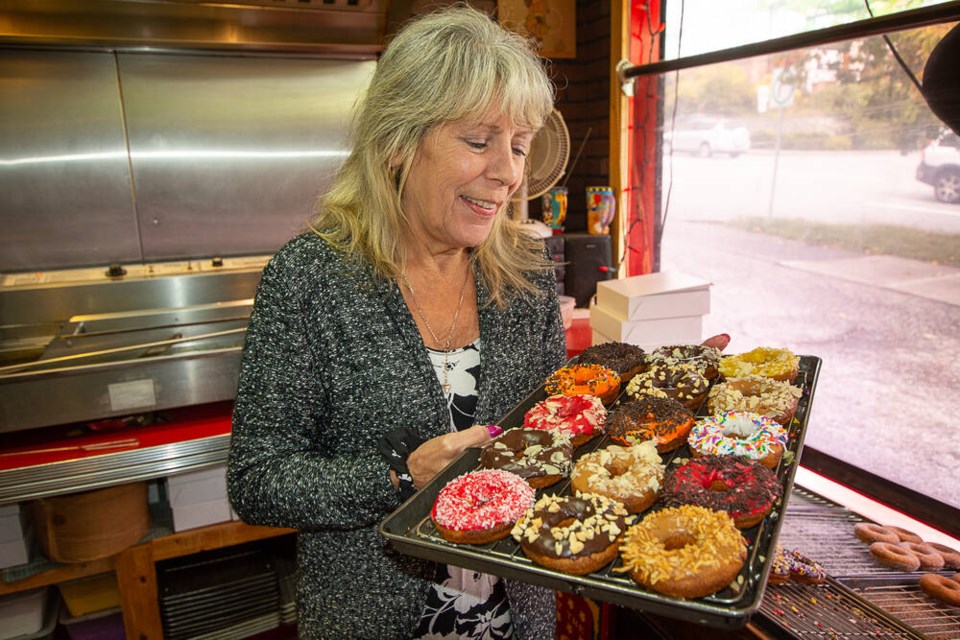 Harmony owner Carol Haggerty makes sure every doughnut is decorated properly. | Nick Laba / North Shore News 