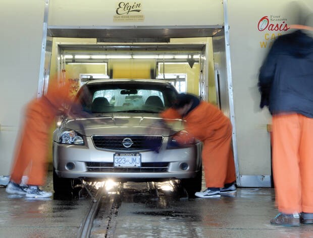 Oasis car wash crews clean a vehicle in March, 2017.| Mike Wakefield / North Shore News files 