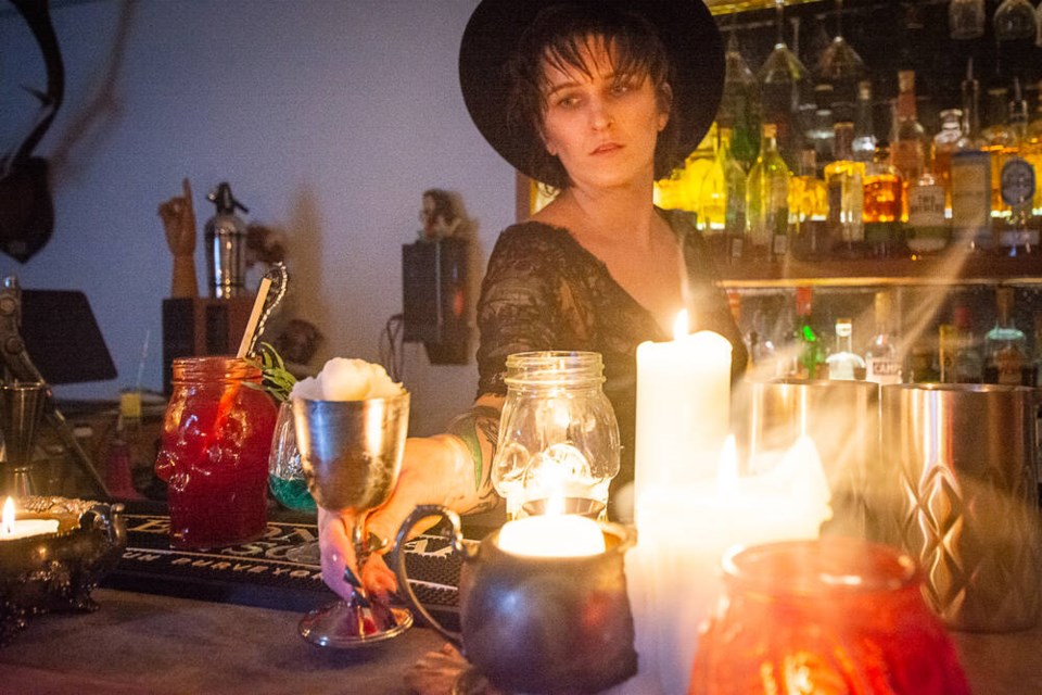 Sons of Vancouver bartender Amanda MacMullin, dressed as Lydia from Tim Burton’s ‘Beetlejuice,’ serves a spooky slush in a silver chalice. | Nick Laba / North Shore News 