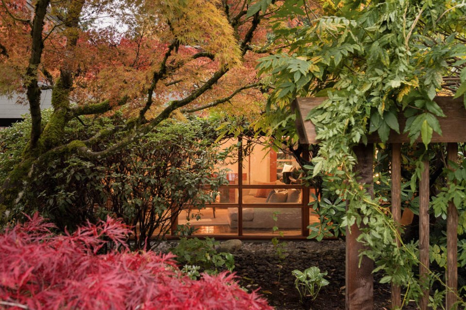 Japanese maple, rhododendron and river stones frame a picture window of a Fred Hollingsworth-designed home in North Vancouver. | Barbara Tili 