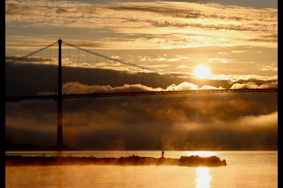 The sun fights through the fog in this stunning photo of Lions Gate Bridge taken from West Vancouver’s Ambleside area on Nov. 29, 2023. | Neela Falconer 