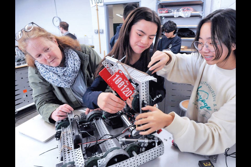 West Vancouver teacher Cari Wilson with Grade 9 students Esme Jessup and Jamie Lee as they work on their robot in a class at West Vancouver’s robotics academy. | Paul McGrath / North Shore News 
