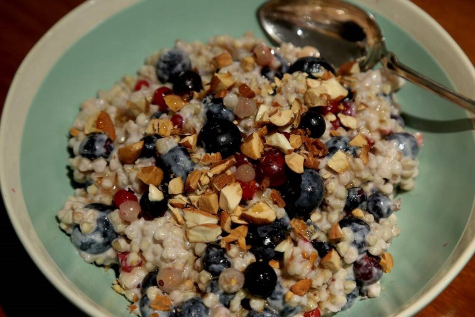 Buckwheat and goat milk porridge pairs perfectly with frozen blue, josta, and currant berries from our garden. | Laura Marie Neubert 