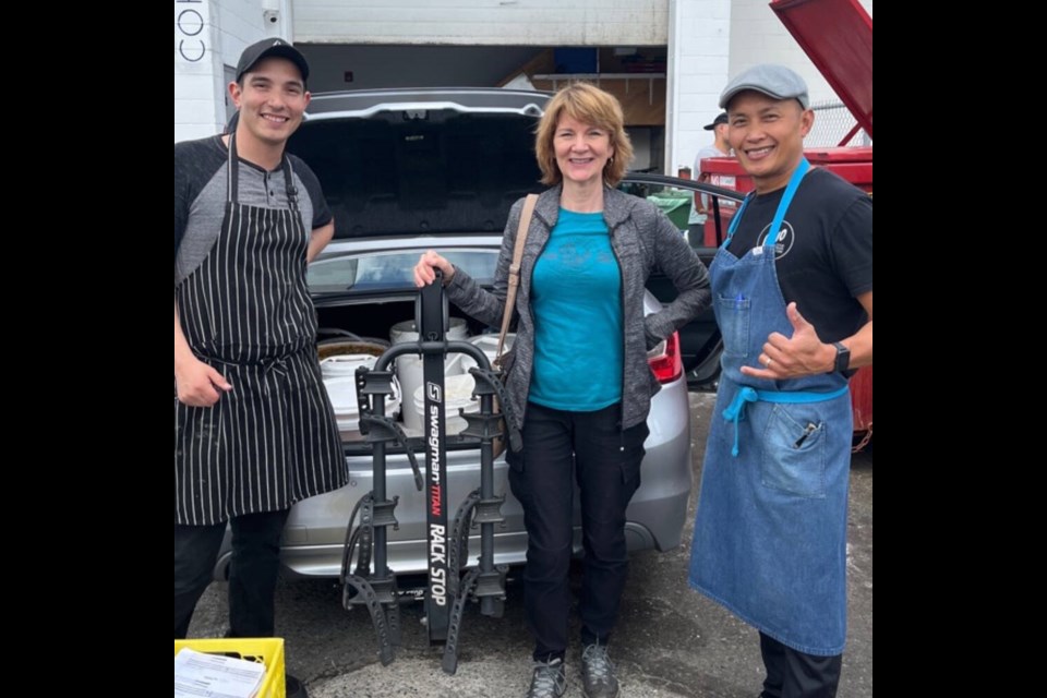 Volunteer Janet McDonnell from Vancouver Food Runners picks up buckets of soup from Ono Vancouver, a catering company that runs a community meal program. | Courtesy of Janet McDonnell 
