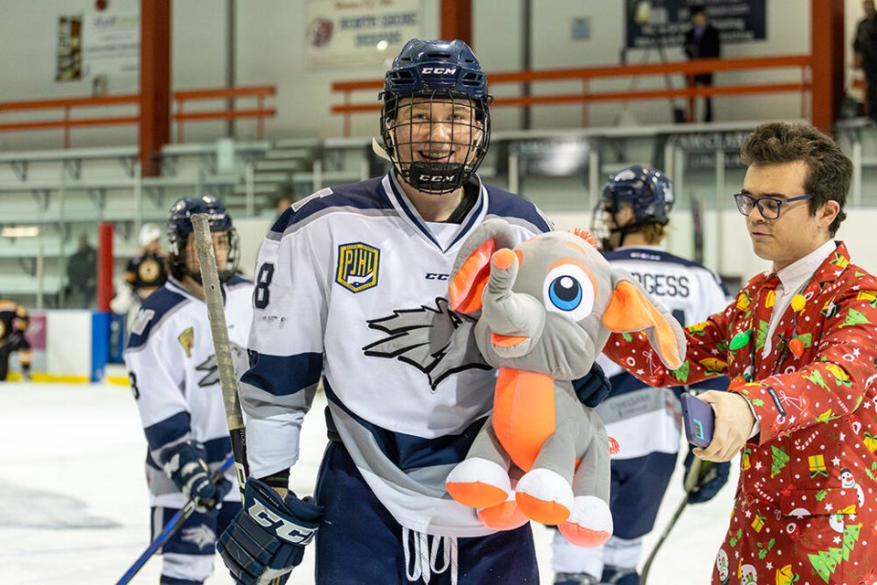 North Van Wolf Pack captain JJ Pickell enjoys a stuffy hug after scoring the opening goal on Teddy Bear Toss day Dec. 9 at Harry Jerome Arena, setting off a cascade of stuffed animals to be donated to the North Shore Christmas Bureau. | Kyle Gill / North Van Wolf Pack 