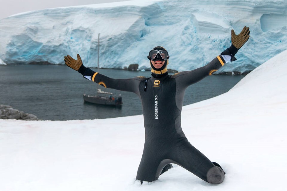 Connor Emeny celebrates after completing his 3.9 kilometre swim in the frigid waters of Antarctica. The leg took him one hour and 43 minutes, which is 43 minutes slower than his fastest Ironman swim. | Courtesy of Connor Emeny 