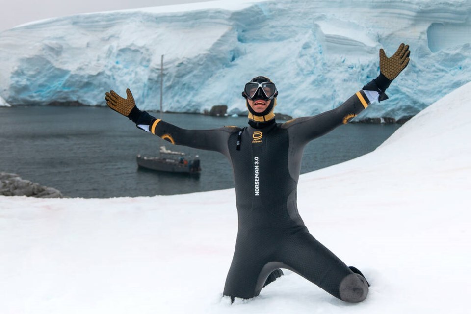 Connor Emeny celebrates after completing his 3.9 kilometre swim in the frigid waters of Antarctica. The leg took him one hour and 43 minutes, which is 43 minutes slower than his fastest Ironman swim. | Courtesy of Connor Emeny 