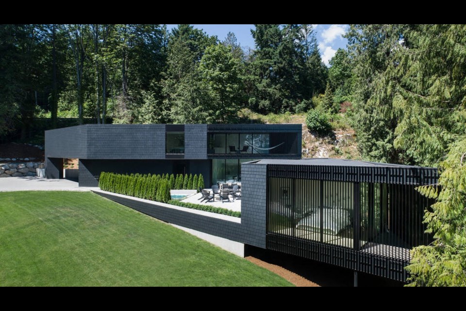 The exterior West Vancouver's Howard Residence is covered in charcoal coloured shingles. The property went on the market on March 27, 2024. | Andrew Latreille