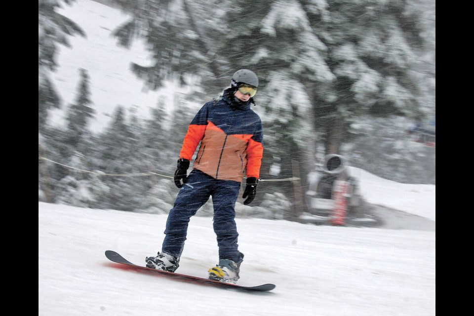 A snowboarder slides during falling snow at Cypress on Jan. 5, 2024. El Nino provided a wild ride for North Shore ski hills this season. | Paul McGrath / North Shore News 