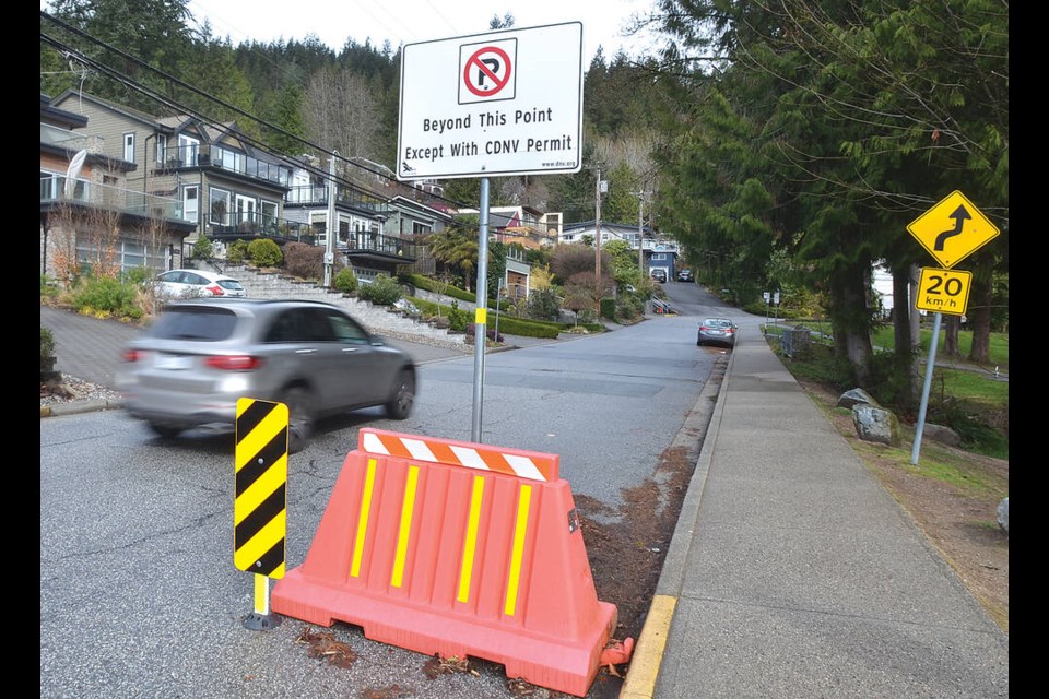 A car drives by a resident-only parking area in Deep Cove. The District of North Vancouver is moving to increase the number of resident-only parking zones in the area. | Paul McGrath / North Shore News 