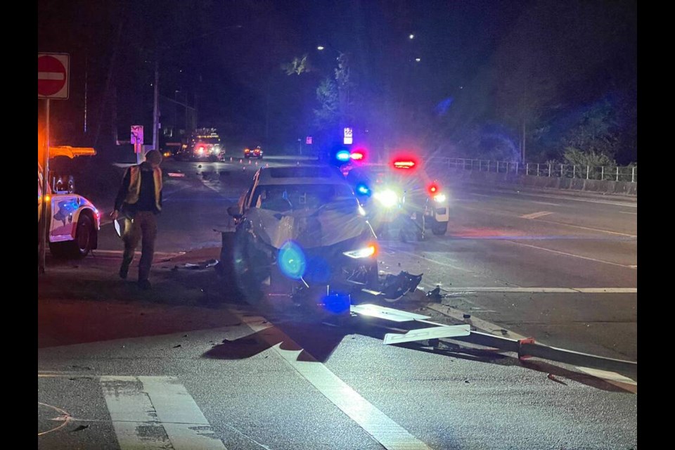 A white SUV was totalled after colliding with a power pole and lamp post on Capilano Road early Tuesday morning. | Pat Bell 