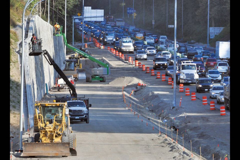 Workers install a facade on the retaining wall along the Cut in North Vancouver in September of 2019. | North Shore News files 