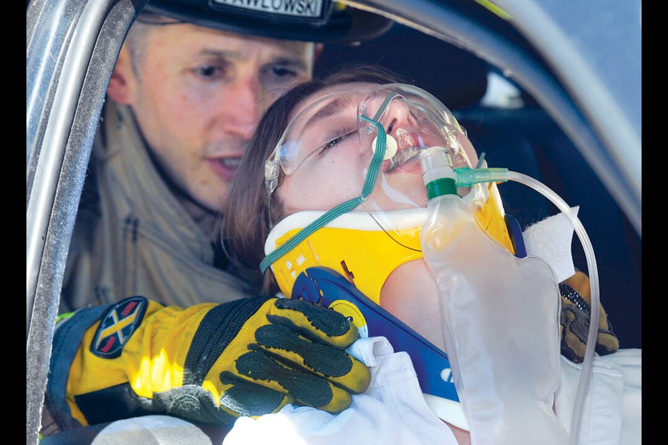 A student actors play the part of an accident victim during a mock crash scenario May 10 at North Vancouver’s Argyle Secondary. | Paul McGrath / North Shore News 