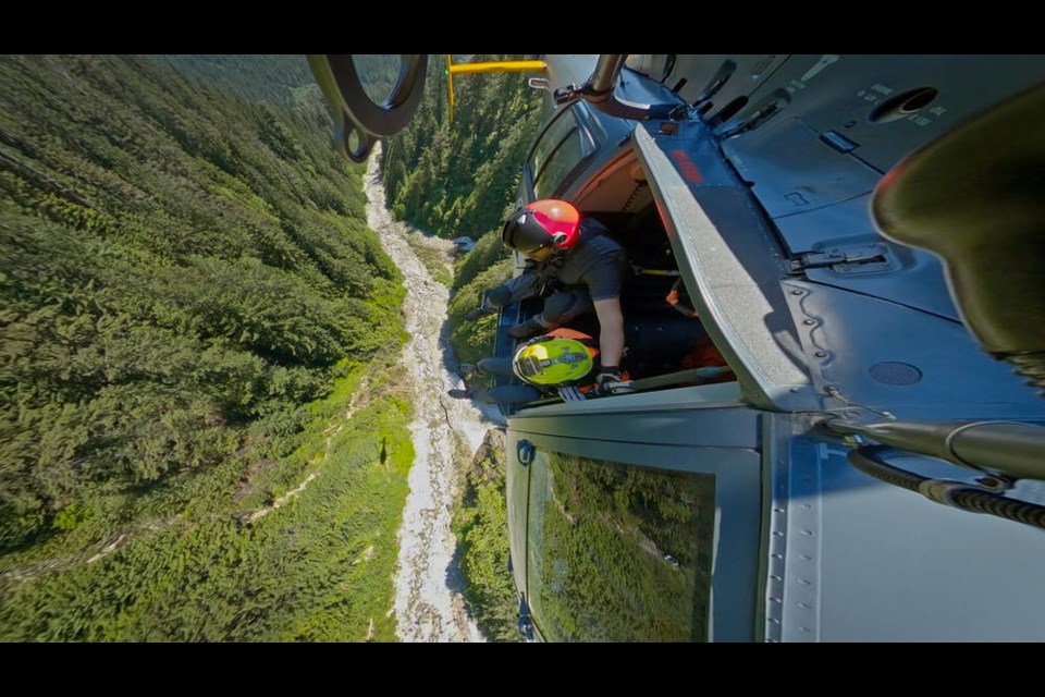 Two North Shore Rescue volunteers scour a North Vancouver backcountry creek in search of an injured hiker, a scene from Season 2 of 'Search and Rescue: North Shore.' |Courtesy of Silvapark Films. 