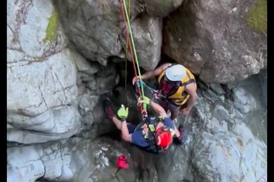 A District of North Vancouver Fire and Rescue Services member assists a cliff jumper out of North Van’s Lynn Canyon, June 9, 2024. | @DNVFRS/X 