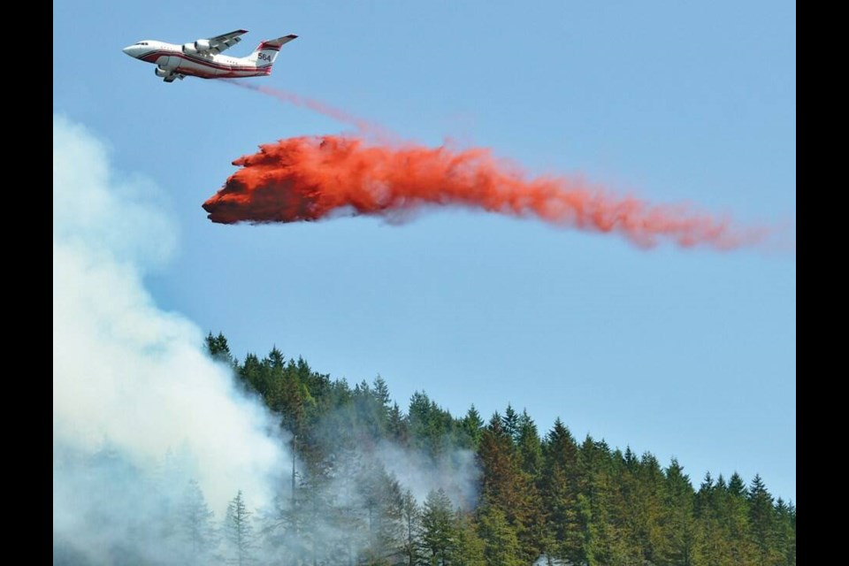 An airtanker dumps a load of fire retardant on a wildfire burning off Highway 99 above Horseshoe Bay in June of 2023. | Paul McGrath / North Shore News 