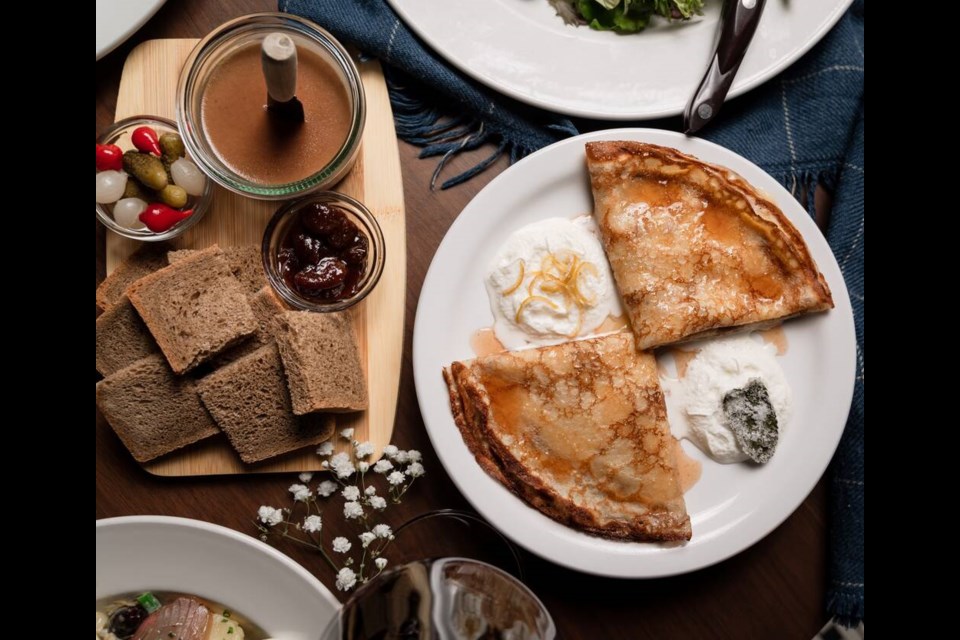 A crepe dish served alongside bread and condiments at the newly opened Merèon. | Nora Hamade 