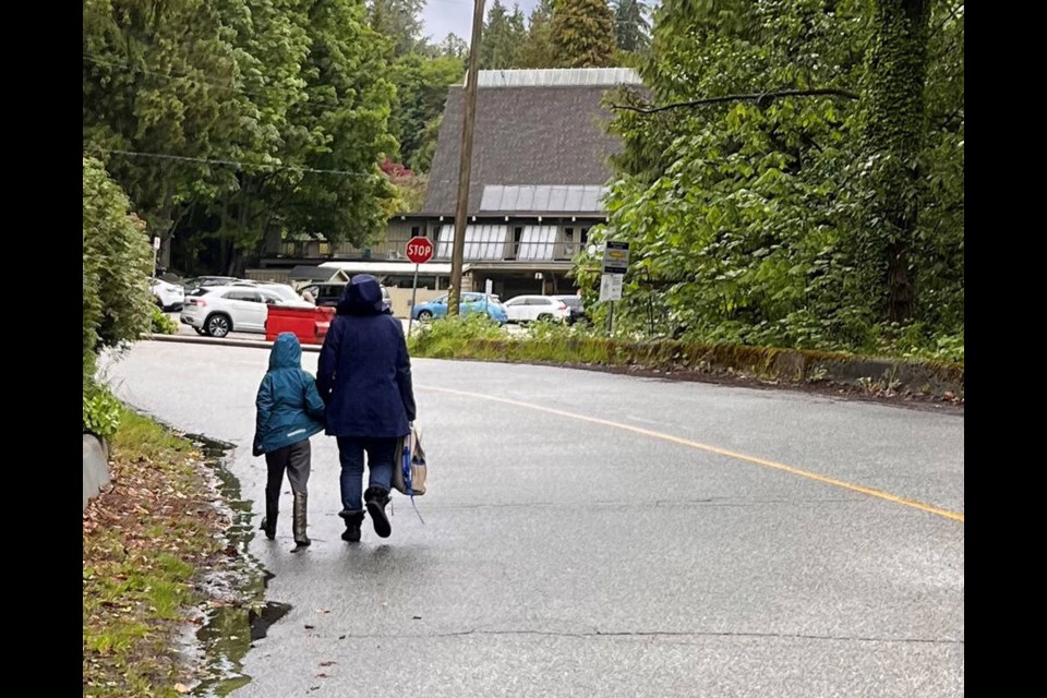 With no shoulder or sidewalk to use, a parent and child walk directly on Wildwood Lane in West Vancouver. | Shirley Anthony 