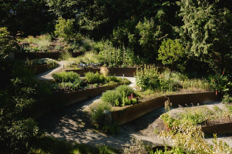 A sloped garden wraps around the side of the home. | Conrad Brown