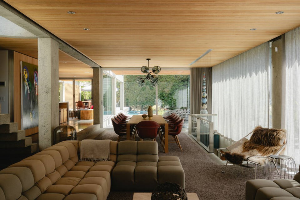 The main floor living area is flanked by floor-to-ceiling windows. | Conrad Brown 