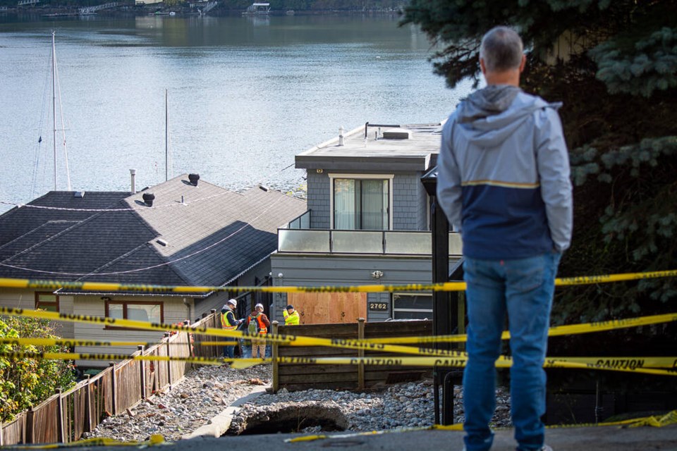A Deep Cove resident looks over the extensive damage to properties on the 2700 block of Panorama Drive, on Oct. 22. Nick Laba / NSN 