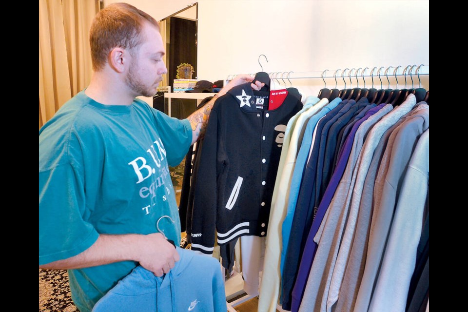 Co-owner Shawn Avantini shows off pieces on the racks at his new store. | Paul McGrath / North Shore News