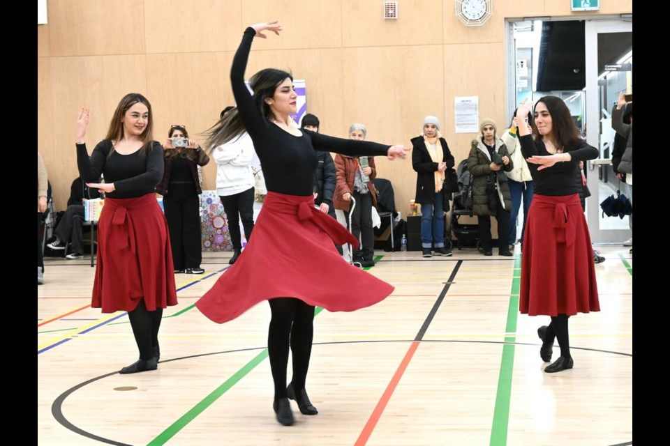 Three women perform a traditional Iranian dance to a large crowd at a Nowruz market held March 9 at North Vancouver's Lions Gate Community Centre. | Abby Luciano / North Shore News 