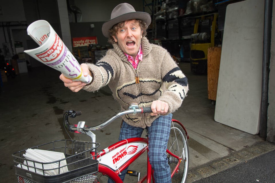 Armed with a fresh stack of newspapers, Grant Lawrence rides out of the North Shore News warehouse. Lawrence’s first job was an NSN paperboy in the early 1980s. | Nick Laba / North Shore News 